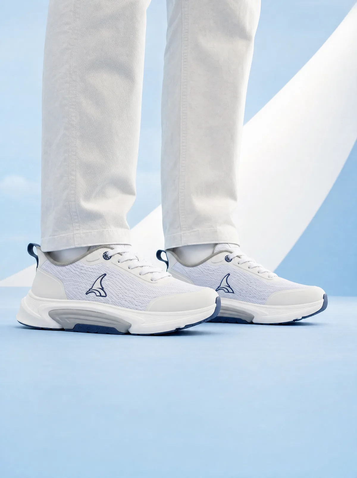 A senior standing at a low three-quarter angle. The outsole meets the ground wider than the foot above it.